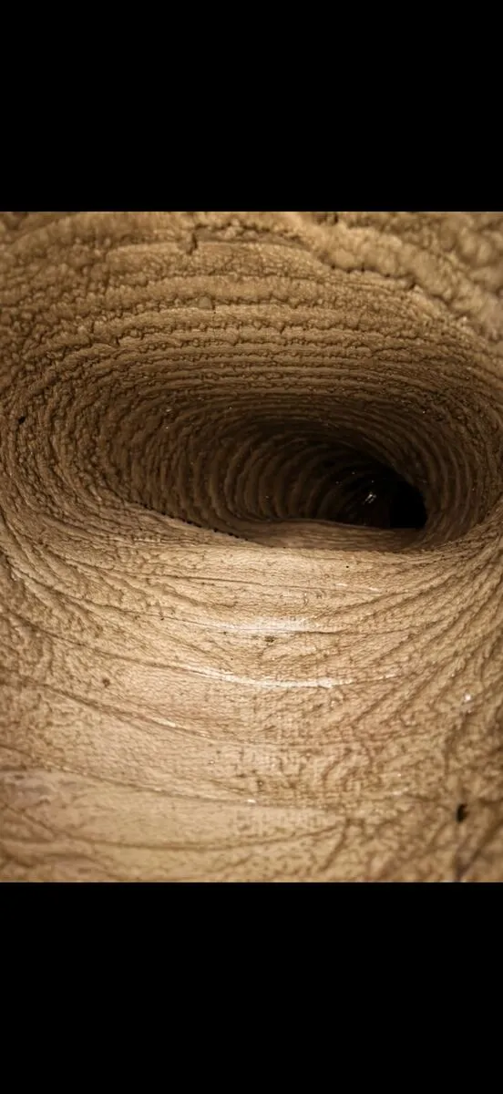 Before: flexible air duct coated in heavy dust buildup