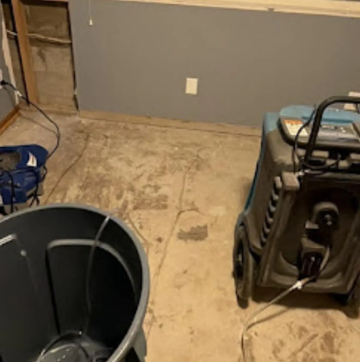 Commercial dehumidifier removing storm water moisture from an Oklahoma home