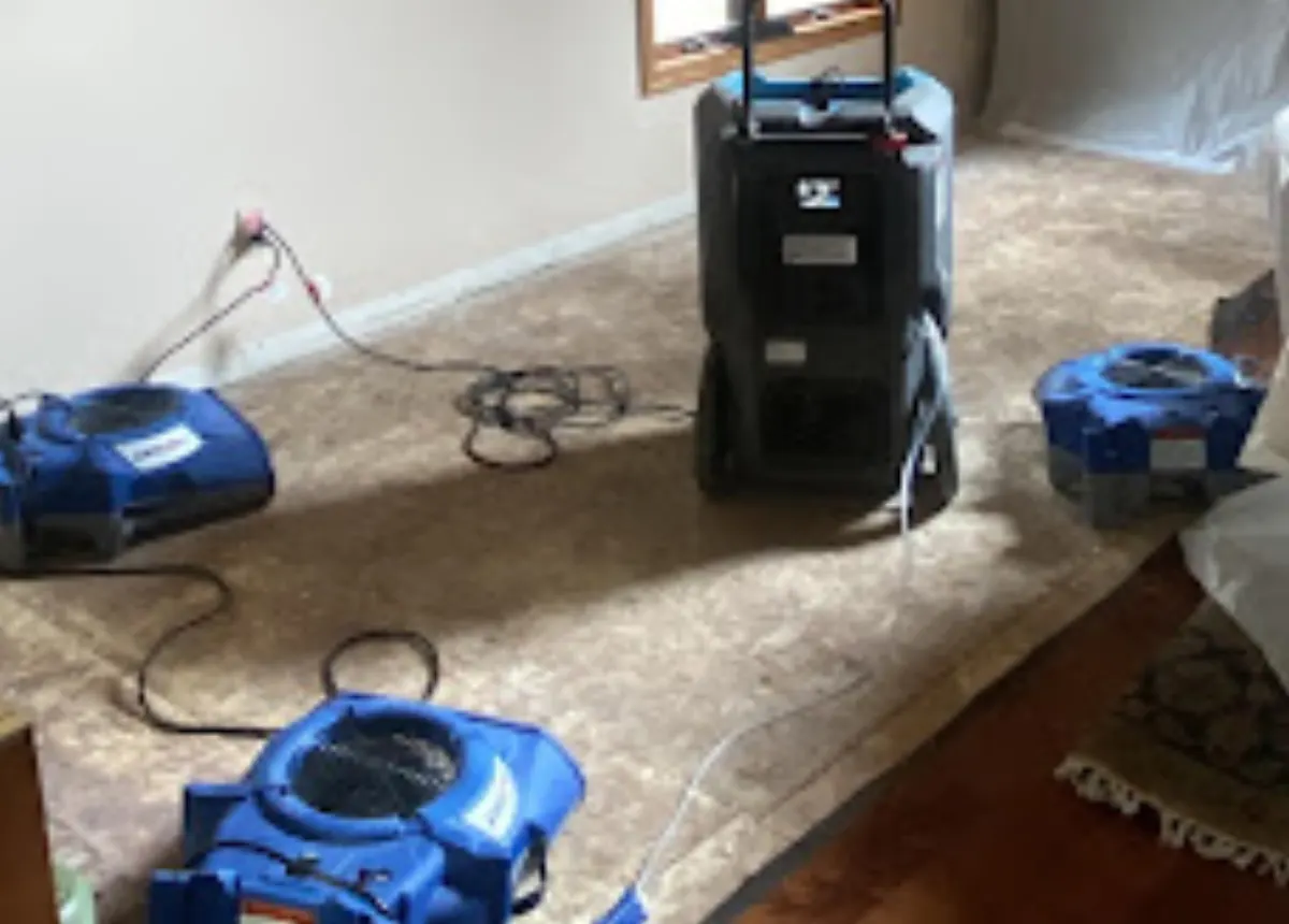 Industrial drying equipment removing fire-suppression water from a damaged Oklahoma home